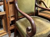 a chair that is sitting in front of a mirror