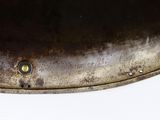 a close up of a metal object on a white surface