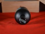 a black object sitting on top of a red blanket