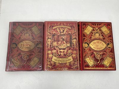 three books sitting on top of a white table next to each other