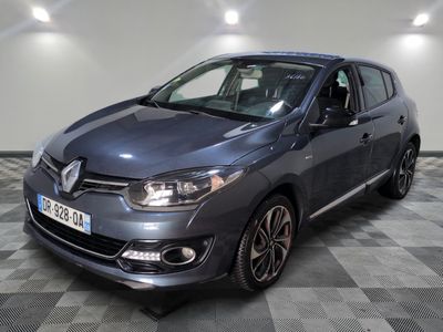 a grey car is parked in a room with a checkered floor
