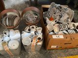 many cups and saucers in a box on the floor