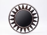 a picture of a round mirror with a black and white design