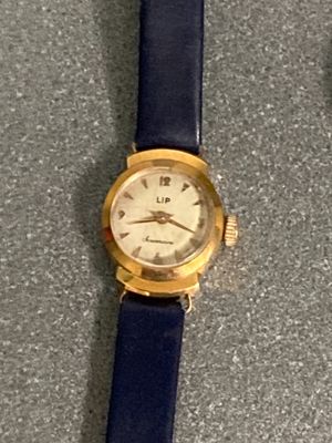 two watches sitting on a table next to each other
