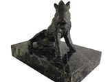 statue of a dog sitting on a marble base on a white background
