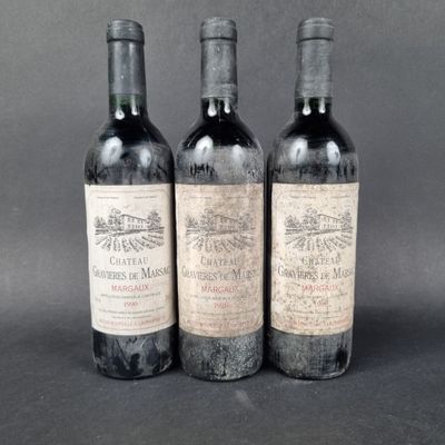 three bottles of wine sitting on top of a table next to each other