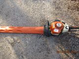 an image of a chainsaw laying on the ground