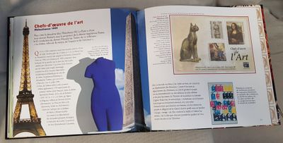 an open book with a picture of the eiffel tower in the background