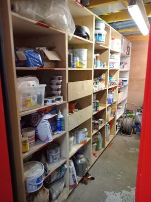a room filled with lots of paint and supplies