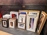 a lot of picture frames on a table in a room