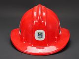 a close up of a red fireman ' s helmet on a black background