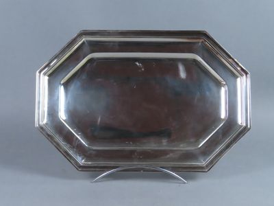 un plateau d'argent antique sur un support sur fond gris
