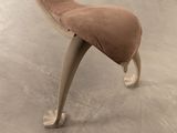 a chair that has a foot rest on it in a room