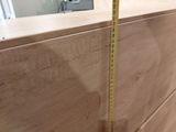 a measuring tape that is on the side of a cabinet