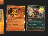 several pokemon cards are displayed on a black surface