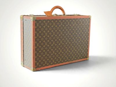 a brown and tan suitcase sitting on top of a white surface