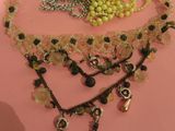 a picture of a necklace with beads and charms on it