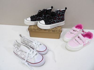 three pairs of shoes sitting on a table next to a box