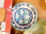 a blue and white bowl sitting on top of a box