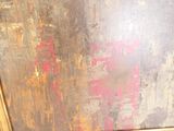 a cat that is sitting on the floor in front of a painting