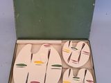 four coasters in a box with a design on them