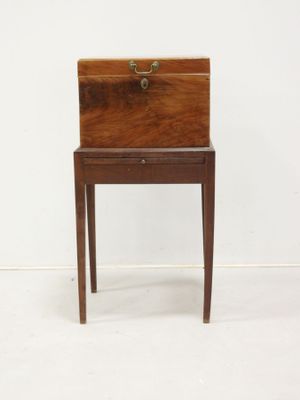 an old wooden desk with a drawer on top of it