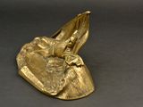 brass figurine of a woman in a boat with a bird on it