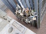a pile of scrap on the ground next to a fence
