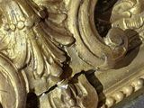 a close up of a gold clock on a marble table