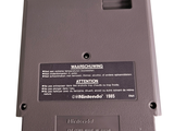 a close up of a nintendo game controller on a white surface