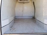 a white van with the back door open and a window open
