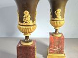 two vases sitting on top of each other on a table