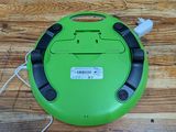 a close up of a green vacuum cleaner on a wooden floor