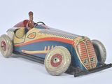 a small toy car with a man in the driver ' s seat