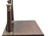 a wooden desk with a pen and a telescope on it