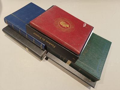 several books are stacked on top of each other on a table