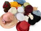 a pile of hats and gloves on a white surface