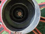 a close up of a red wagon wheel with a black spoke