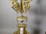 pair of antique brass candelabs with figurines on pedestals