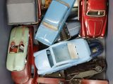 many toy cars in a blue box on the floor