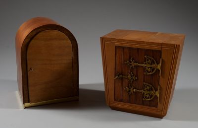 a small wooden box with a door and a small wooden box with a door