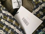 the label is on the jacket of a woman ' s jacket
