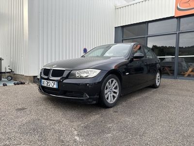 a picture of a black car parked in front of a building