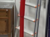 a picture of a red coat stand in a room
