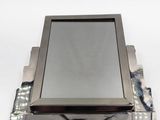 a tablet computer sitting on top of a piece of metal