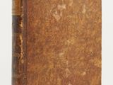 an old book sitting on top of a table next to a white background