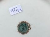 a white plate with a green design on it on a wooden table