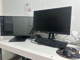 two computer monitors and a keyboard on a desk