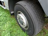 a close up of a flat tire on a truck