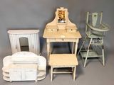 a lot of miniature furniture on display on a gray background